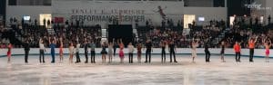 Row of skaters bowing at the end of ice show