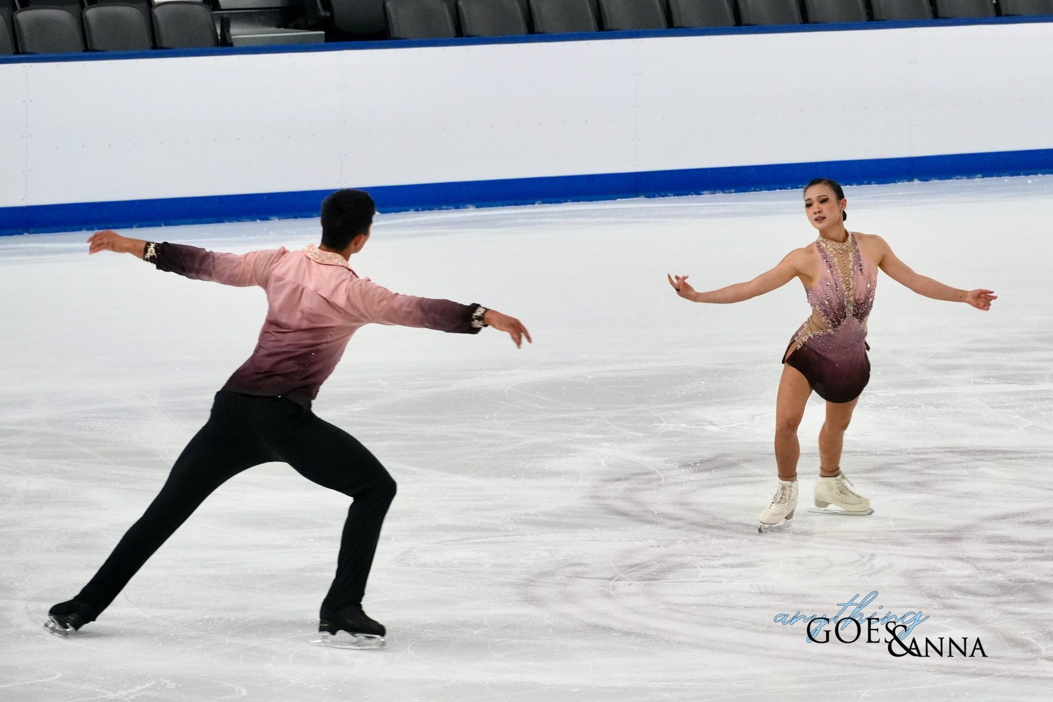 Audrey Shin and Spencer Howe circle each other on the ice, Shin faces the audience, and Spencer has his back to the camera